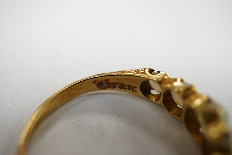 A late Victorian yellow metal and five stone graduated white opal set half hoop ring, the inner shank engraved 'Bran? Ap 4.89', size L.